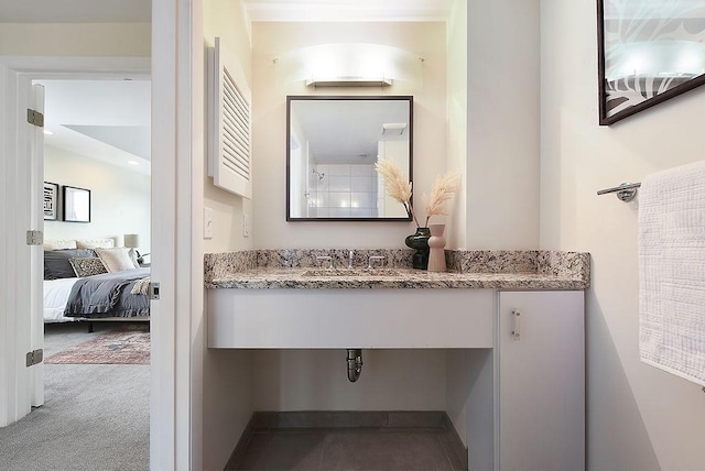 bathroom featuring ensuite bathroom and a sink