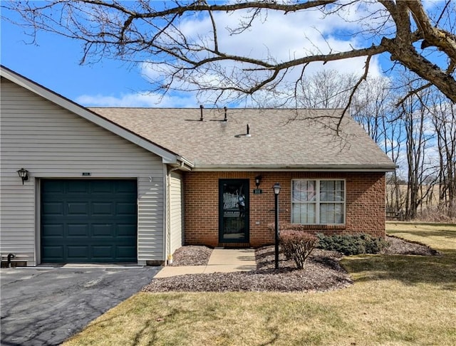 view of front of house featuring brick siding, a shingled roof, a front lawn, aphalt driveway, and an attached garage