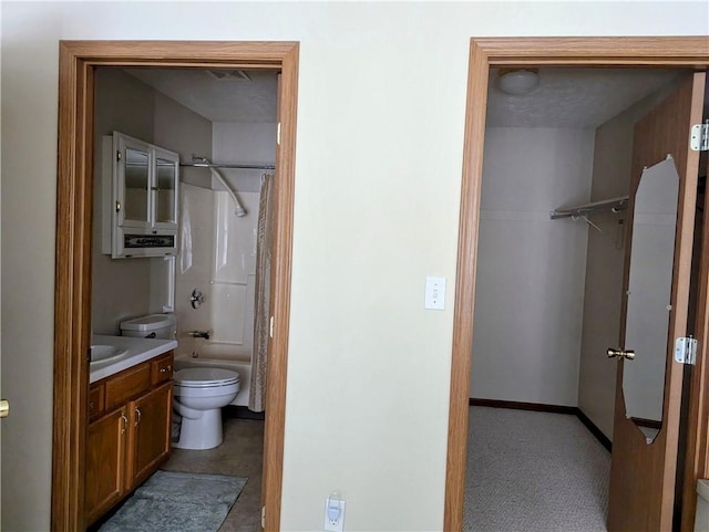 bathroom with toilet, vanity, baseboards, and washtub / shower combination