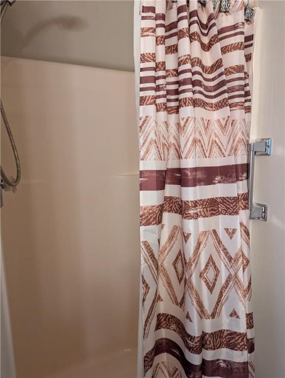 full bathroom with a shower with shower curtain