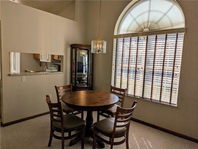 dining space featuring baseboards and an inviting chandelier