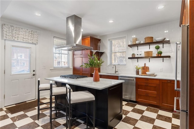 kitchen featuring a sink, stainless steel appliances, light floors, and island range hood