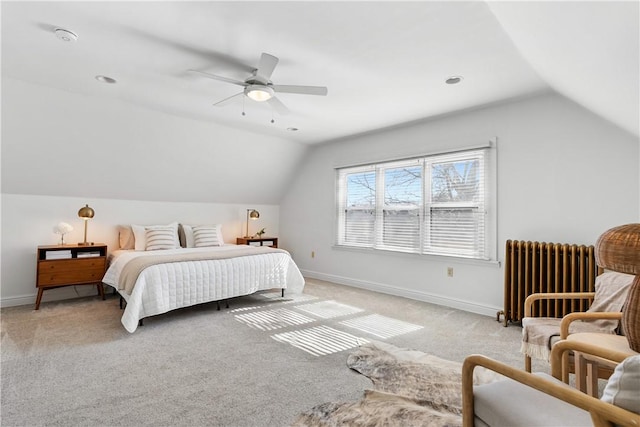 bedroom with light colored carpet, radiator heating unit, baseboards, and lofted ceiling