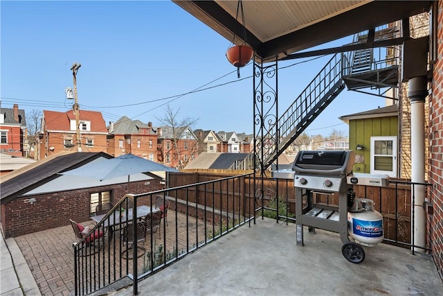 view of patio / terrace featuring a balcony, area for grilling, and a residential view