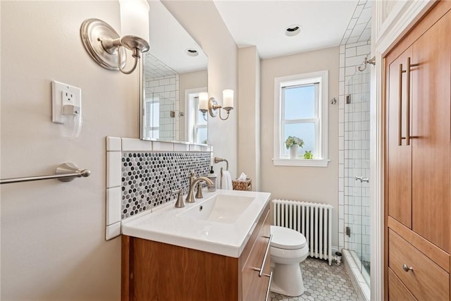 full bath featuring tasteful backsplash, radiator, toilet, a stall shower, and vanity