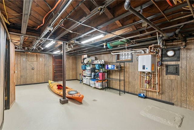 unfinished basement with water heater and wooden walls