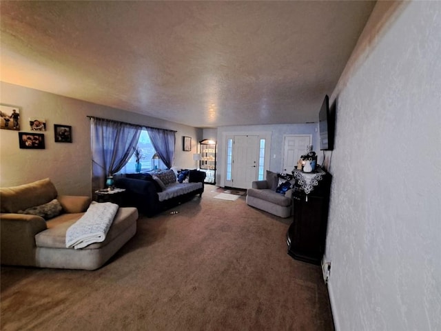 living room featuring a textured ceiling, carpet, and a textured wall