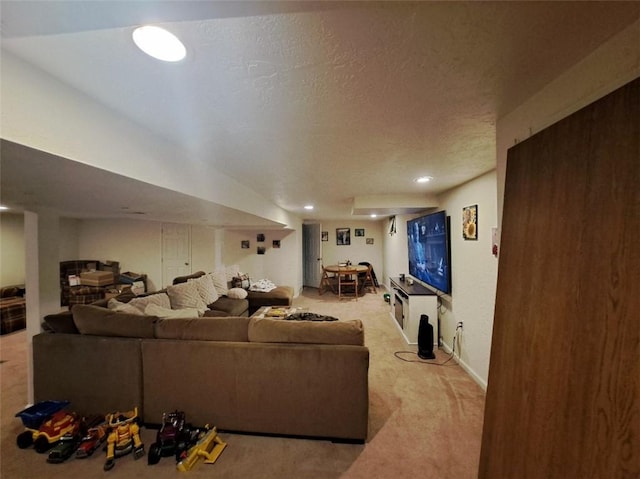 living area with recessed lighting, carpet, and a textured ceiling