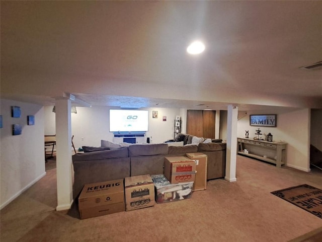 living area with baseboards, visible vents, and carpet floors