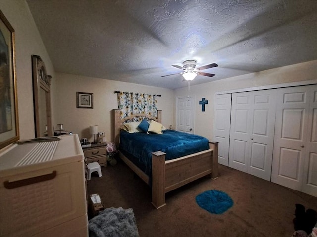 bedroom featuring dark colored carpet, a textured ceiling, and a ceiling fan