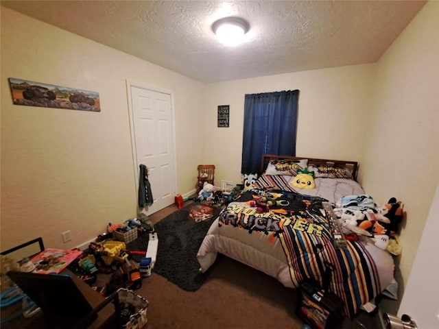 bedroom with carpet floors and a textured ceiling