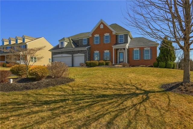 view of front of property with a front lawn, brick siding, and a garage