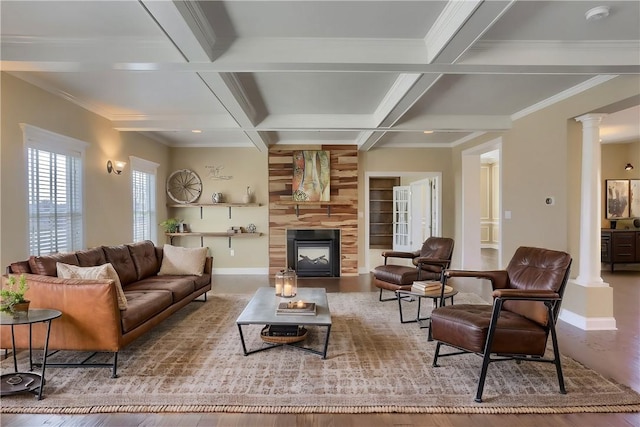 living area with baseboards, coffered ceiling, decorative columns, beamed ceiling, and a large fireplace