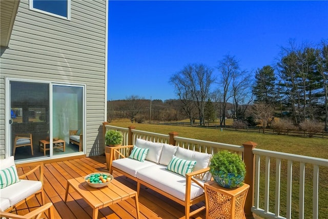 deck featuring an outdoor living space, a yard, and fence