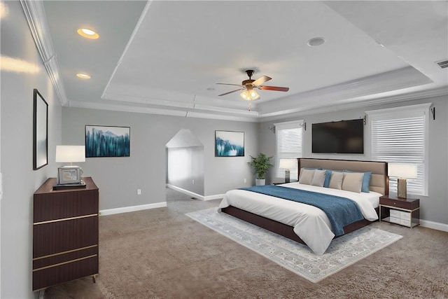 bedroom featuring ornamental molding, a tray ceiling, recessed lighting, carpet flooring, and baseboards