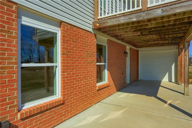 view of side of home with brick siding and concrete driveway