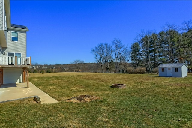 view of yard with a fire pit and an outbuilding