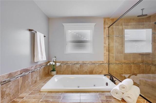 full bath with a jetted tub, radiator heating unit, a healthy amount of sunlight, and a tile shower