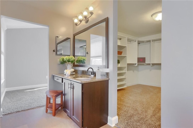 bathroom featuring vanity and baseboards