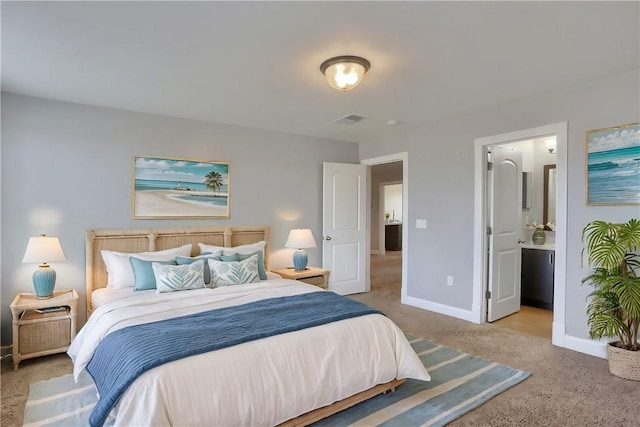 carpeted bedroom featuring baseboards, visible vents, and connected bathroom