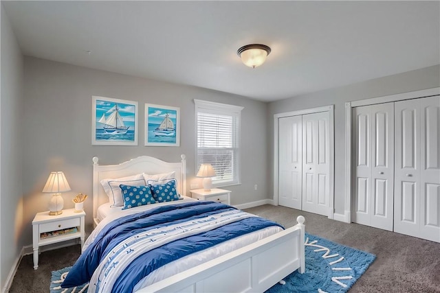 bedroom with baseboards, two closets, and carpet