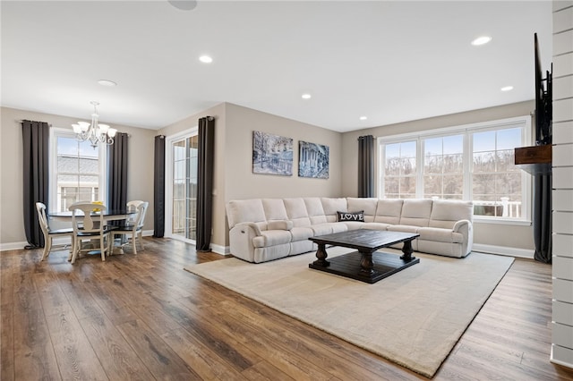 living room with recessed lighting, a chandelier, baseboards, and wood finished floors