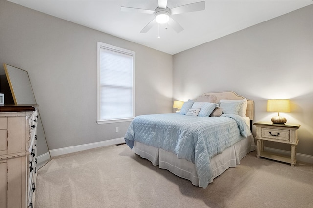 bedroom featuring baseboards, light colored carpet, and ceiling fan