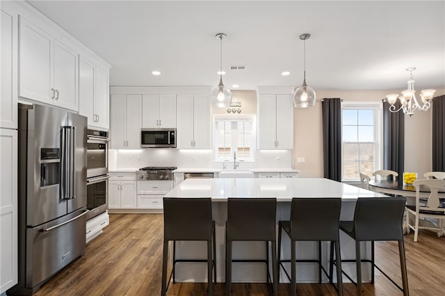 kitchen with stainless steel appliances, plenty of natural light, visible vents, and decorative backsplash