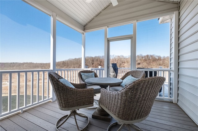 sunroom / solarium featuring lofted ceiling