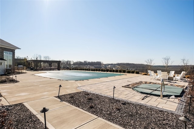 community pool with a patio area, a pergola, and fence