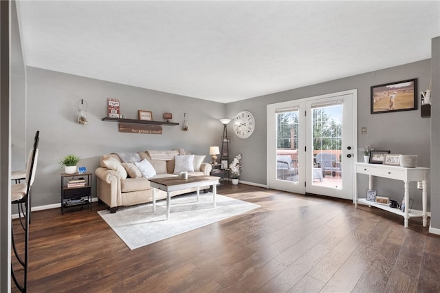 living room featuring baseboards and wood finished floors