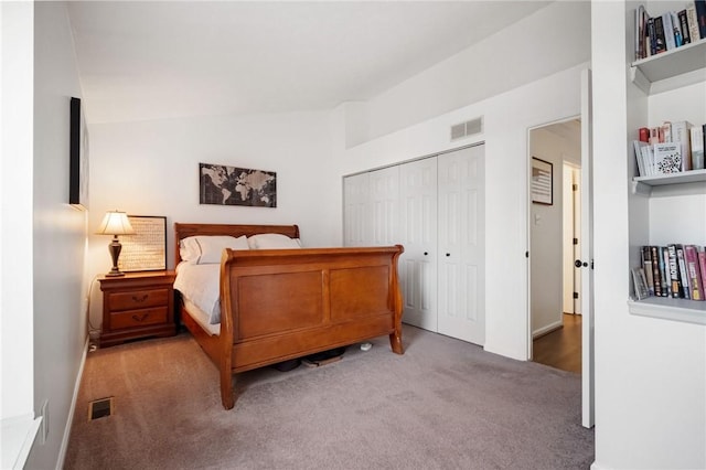 bedroom with lofted ceiling, carpet, visible vents, and a closet