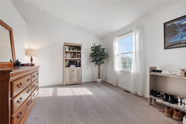 living area with visible vents, light colored carpet, and lofted ceiling