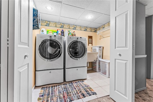 washroom with tile patterned floors and washing machine and dryer