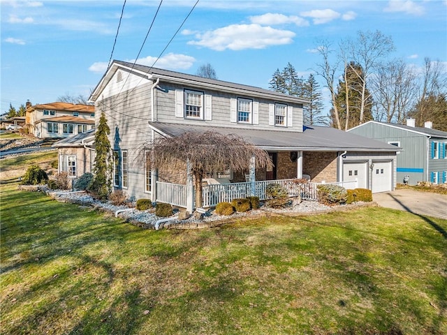 view of front of home with a garage, covered porch, concrete driveway, and a front yard