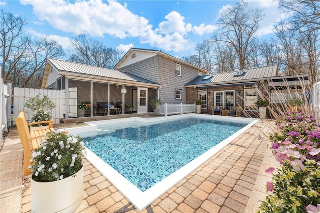 view of swimming pool with a patio area, fence, a fenced in pool, and a sunroom