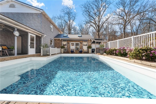 view of pool with an outbuilding, a patio, a fenced in pool, fence, and a storage structure