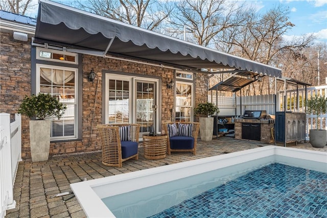 view of pool featuring fence and a grill