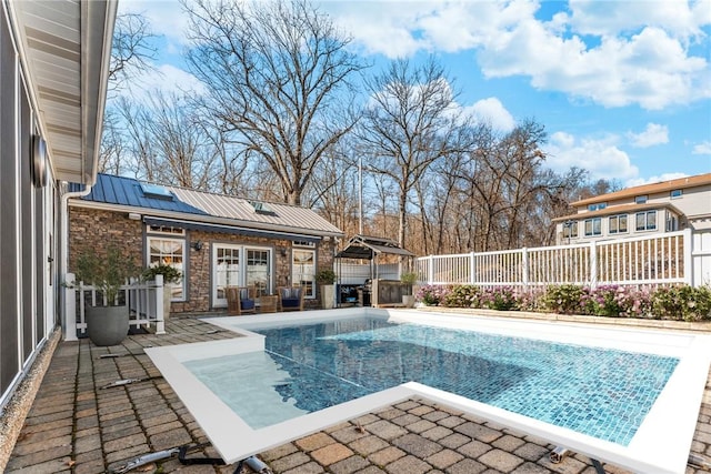 view of pool featuring a fenced in pool, a patio, a fenced backyard, and a storage structure