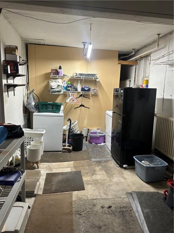 basement with washer / dryer and freestanding refrigerator