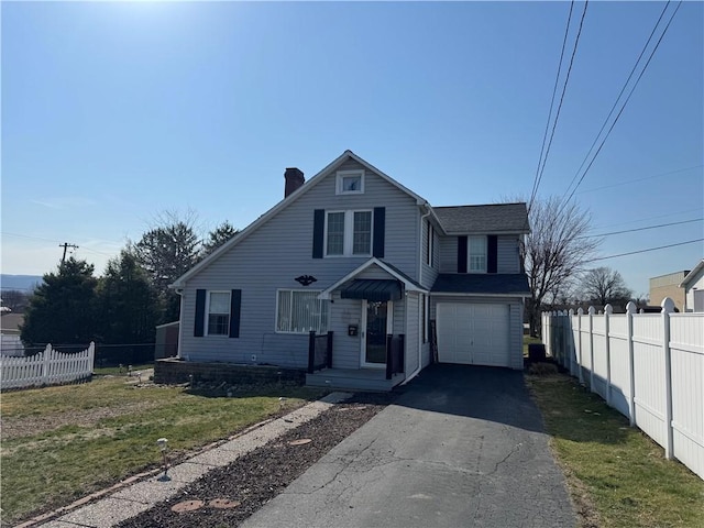 view of front of home featuring a front lawn, driveway, fence, a garage, and a chimney