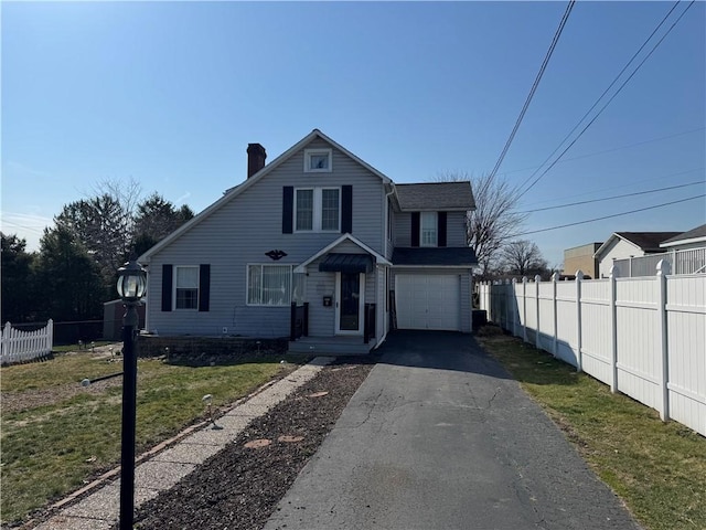 view of front of home featuring fence, a front yard, a chimney, a garage, and driveway