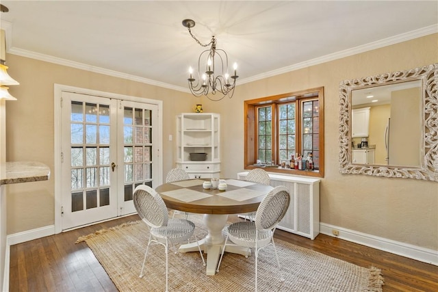 dining area featuring crown molding, baseboards, french doors, an inviting chandelier, and hardwood / wood-style flooring