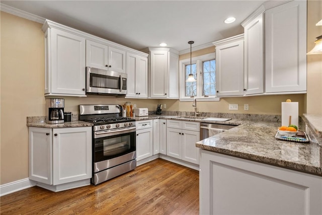 kitchen featuring a sink, appliances with stainless steel finishes, and white cabinetry