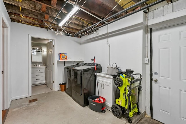 unfinished basement featuring washing machine and dryer and a sink