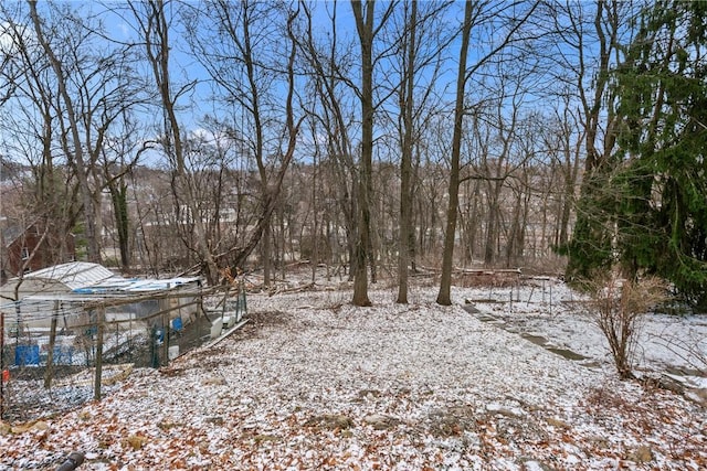 yard layered in snow featuring an outdoor structure