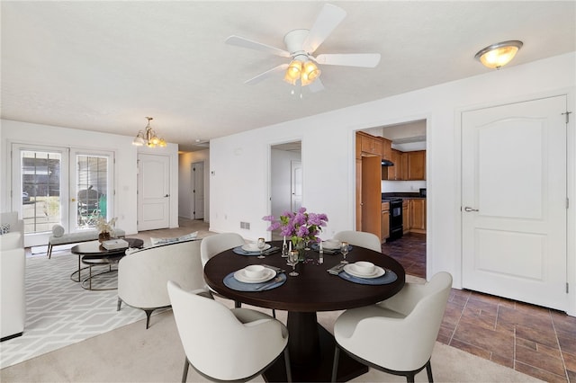 dining space with visible vents and ceiling fan with notable chandelier