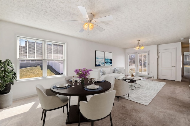 dining room featuring a healthy amount of sunlight, a textured ceiling, and carpet floors