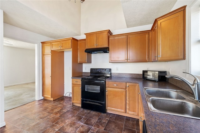 kitchen featuring dark countertops, black appliances, under cabinet range hood, a textured ceiling, and a sink