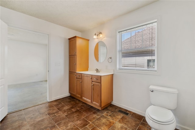 bathroom featuring toilet, baseboards, and visible vents